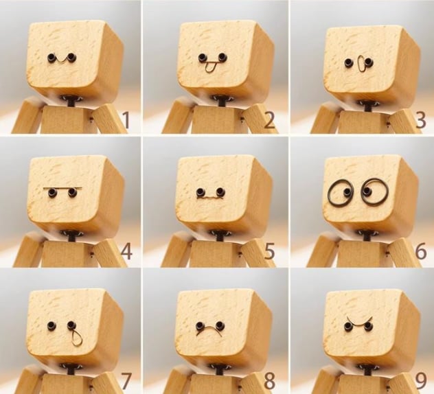 Charmante kleine Holzfigur, die sich mit 12 magnetischen Gesichtsausdrücken bewegt